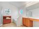 Bright bathroom with a soaking tub, vanity area, octagonal window, and natural light at 154 Desiree Aurora St, Winter Garden, FL 34787