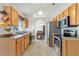 Functional kitchen featuring wood cabinets, stainless steel appliances, and tile flooring at 154 Desiree Aurora St, Winter Garden, FL 34787