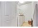 Clean laundry room with white appliances, tile flooring, and ample storage space at 154 Desiree Aurora St, Winter Garden, FL 34787