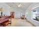 Bright living room with plush recliner, piano, and ample natural light at 154 Desiree Aurora St, Winter Garden, FL 34787