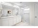 A modern bathroom features a glass shower, a double sink vanity, and closet access at 16249 Taliesin St, Winter Garden, FL 34787