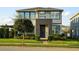 Inviting two-story home with a modern facade, well-maintained landscaping, and a striking blue front door at 16249 Taliesin St, Winter Garden, FL 34787