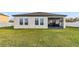 Spacious backyard features lush lawn and views of the back of the property at 16390 Blooming Cherry Dr, Groveland, FL 34736