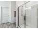 Modern bathroom featuring a glass-enclosed shower with white tiles and a shower head at 16390 Blooming Cherry Dr, Groveland, FL 34736