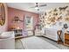 Charming Bedroom features butterfly wall decor, ceiling fan, ample storage and comfortable seating at 16390 Blooming Cherry Dr, Groveland, FL 34736