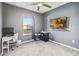 Modern bedroom with gray walls, ample natural light and ceiling fan at 16390 Blooming Cherry Dr, Groveland, FL 34736