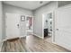 Inviting foyer featuring wood-look floors and showcasing the entryway to a bathroom and living area at 16390 Blooming Cherry Dr, Groveland, FL 34736