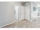 Hallway showcasing wood-look floors, neutral paint, and multiple doors leading to various rooms at 16390 Blooming Cherry Dr, Groveland, FL 34736