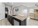 Kitchen island with a stainless steel sink, granite countertop, and view of the living room at 16390 Blooming Cherry Dr, Groveland, FL 34736