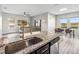 Kitchen island featuring granite countertops and stainless steel sink with an open-concept floor plan at 16390 Blooming Cherry Dr, Groveland, FL 34736
