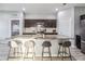 Spacious kitchen with an island and stainless steel appliances and dark brown cabinetry at 16390 Blooming Cherry Dr, Groveland, FL 34736