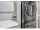 Convenient laundry room with stacked washer and dryer, and a granite countertop at 16390 Blooming Cherry Dr, Groveland, FL 34736