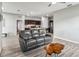 Open-concept layout seamlessly connects the living room with wood-look floors and the modern kitchen at 16390 Blooming Cherry Dr, Groveland, FL 34736