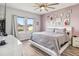 Bright main bedroom with three large windows and luxury vinyl plank flooring at 16390 Blooming Cherry Dr, Groveland, FL 34736