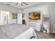Relaxing main bedroom with large TV, dresser, and luxury vinyl plank flooring at 16390 Blooming Cherry Dr, Groveland, FL 34736