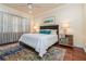 Comfortable bedroom with plush bed, stylish decor, and large window with natural light at 182 Crepe Myrtle Dr, Groveland, FL 34736