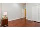 Bedroom features hardwood floors, white trim, and a closet for plenty of storage space at 182 Crepe Myrtle Dr, Groveland, FL 34736