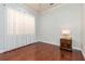 Cozy bedroom featuring hardwood floors, a window with sheer curtains, and a side table at 182 Crepe Myrtle Dr, Groveland, FL 34736