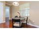 Cozy dining area with modern table and chairs, ample natural light, and hardwood floors at 182 Crepe Myrtle Dr, Groveland, FL 34736