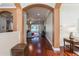 Welcoming foyer with arched doorways, gleaming hardwood floors, and neutral paint, opening to the living areas at 182 Crepe Myrtle Dr, Groveland, FL 34736
