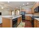 Bright and airy kitchen with stainless steel appliances, spacious countertops, and hardwood floors at 182 Crepe Myrtle Dr, Groveland, FL 34736
