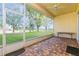 Screened lanai boasting brick floors and views of the landscaped backyard and adjacent golf course at 182 Crepe Myrtle Dr, Groveland, FL 34736