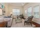 Comfortable living room featuring a bright window, modern furniture, and a decorative carpet over hardwood flooring at 182 Crepe Myrtle Dr, Groveland, FL 34736