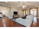 Open-concept living area with hardwood floors, sectional sofa, and seamless flow to other rooms at 182 Crepe Myrtle Dr, Groveland, FL 34736