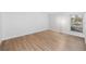 Bright bedroom with minimalist design, wood-look floors, and natural light from the window at 200 Maitland Ave # 131, Altamonte Springs, FL 32701