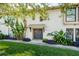 Inviting two-story condo entrance featuring a lush landscaped garden and decorative shade tree at 200 Maitland Ave # 131, Altamonte Springs, FL 32701