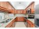 Galley kitchen featuring granite countertops, stainless steel appliances, and ample storage space at 200 Maitland Ave # 131, Altamonte Springs, FL 32701