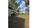 View of the backyard with a few trees and a detached garage or shed at 2426 Barbarossa Ave, Deltona, FL 32738