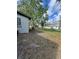 View of the backyard with a few trees and a detached garage or shed at 2426 Barbarossa Ave, Deltona, FL 32738