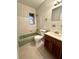 Full bathroom with tiled walls, vanity with sink, toilet, and bathtub at 2426 Barbarossa Ave, Deltona, FL 32738