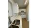 Galley kitchen featuring white cabinets and white appliances at 2426 Barbarossa Ave, Deltona, FL 32738