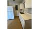 Kitchen with stainless steel sink, white cabinets and white refrigerator at 2426 Barbarossa Ave, Deltona, FL 32738