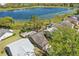 An aerial view of a home with a lake, trees and green grass near the property at 2439 Lake Jackson Cir, Apopka, FL 32703