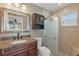 Elegant bathroom with a granite vanity, custom mirror and a tiled walk-in shower at 2439 Lake Jackson Cir, Apopka, FL 32703