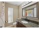 The bathroom features granite countertops, a dark wood vanity and large mirror at 2439 Lake Jackson Cir, Apopka, FL 32703