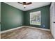 Inviting bedroom features wood-look tile floors, a ceiling fan, and a window for natural light at 2439 Lake Jackson Cir, Apopka, FL 32703
