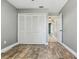 This bedroom features wood-look tile floors and a closet for ample storage space at 2439 Lake Jackson Cir, Apopka, FL 32703