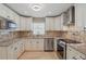 Well-equipped kitchen boasting stainless steel appliances, granite counters, and ample cabinet space at 2439 Lake Jackson Cir, Apopka, FL 32703