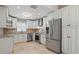 Modern kitchen featuring white cabinets, stainless steel appliances, and granite countertops at 2439 Lake Jackson Cir, Apopka, FL 32703