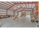 Interior of the barn with concrete floors, metal siding, and overhead lights at 255 Butterfly Forest Rd, Geneva, FL 32732