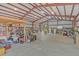 Spacious barn interior features red iron structure, metal walls and overhead lighting at 255 Butterfly Forest Rd, Geneva, FL 32732
