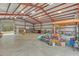 View of the barn interior with exposed rafters and roll-up doors at 255 Butterfly Forest Rd, Geneva, FL 32732