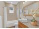 Well-lit bathroom with a tub and shower combination, a large mirror, and elegant vanity at 255 Butterfly Forest Rd, Geneva, FL 32732