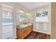 Elegant bathroom with dual sinks, granite countertops and wood cabinets at 255 Butterfly Forest Rd, Geneva, FL 32732