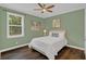 Comfortable bedroom featuring hardwood floors, a ceiling fan, and lots of natural light at 255 Butterfly Forest Rd, Geneva, FL 32732