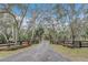 Long private driveway lined with trees leading to a gated entrance at 255 Butterfly Forest Rd, Geneva, FL 32732